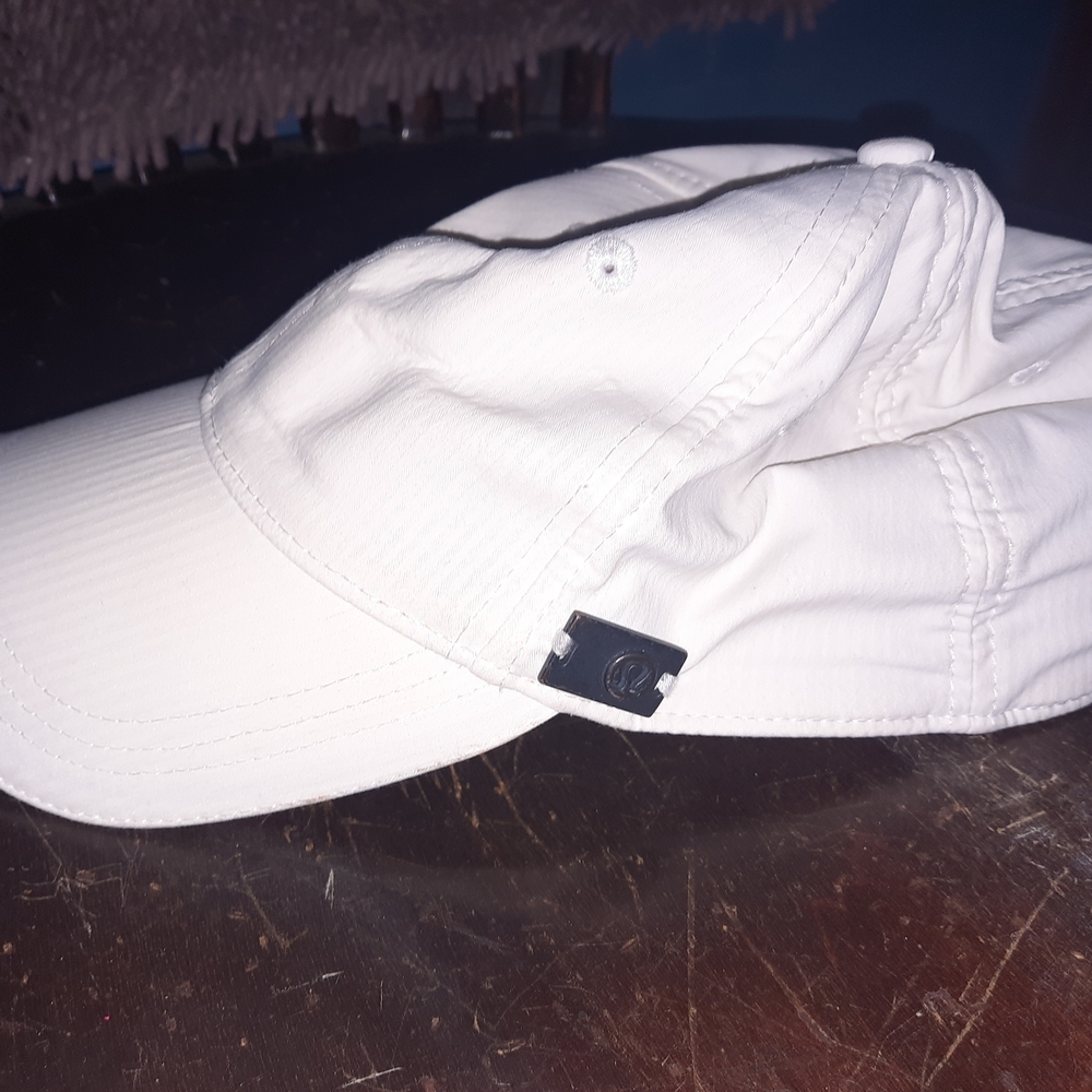 Stylish White Cap with Distinctive Metal Accent